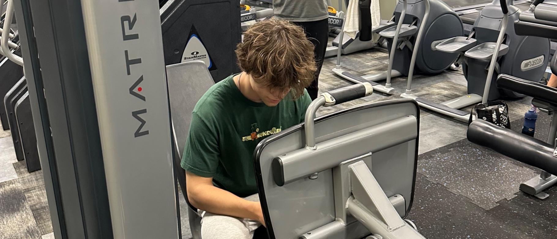 Member using cell phone on equipment