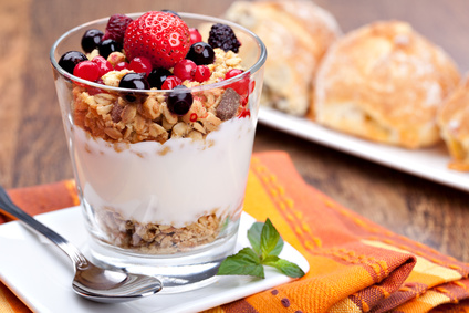 yogurt with muesli and berries in small glass