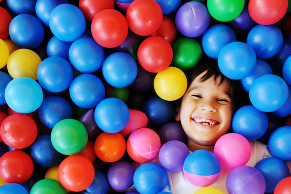 smiling child in ball pit
